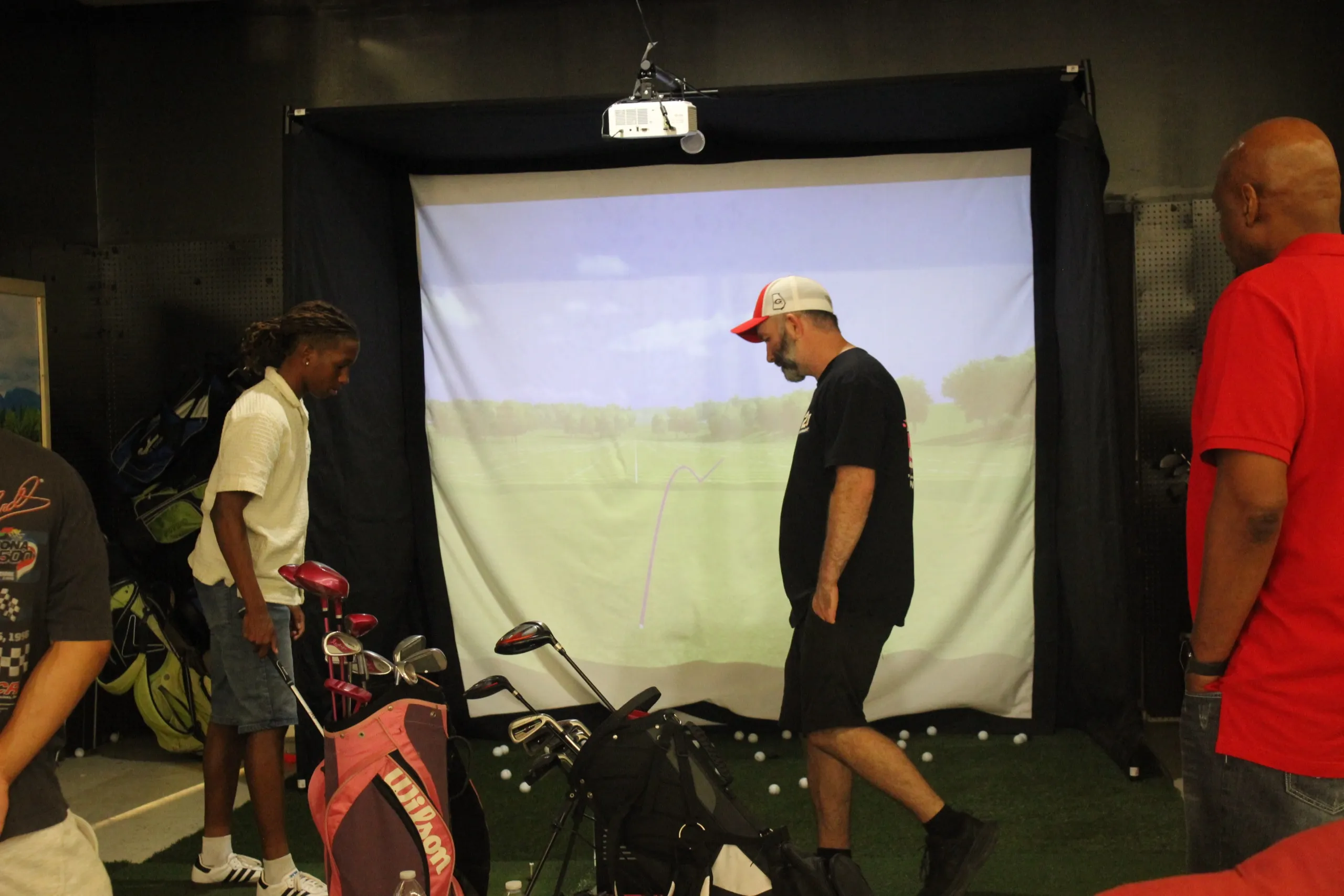 Player teeing off on the golf simulator in Albany, GA