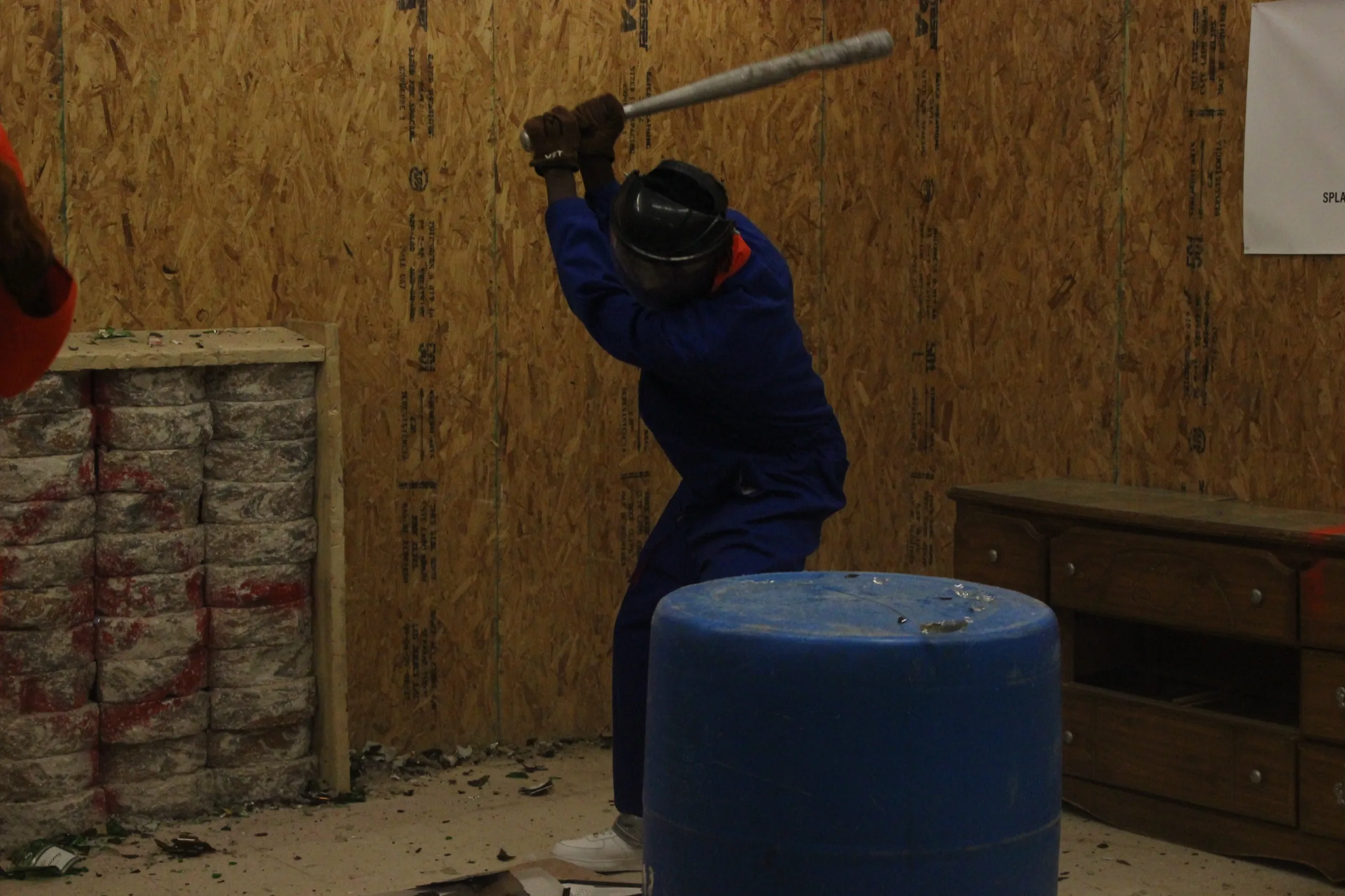 Person swinging a bat in the rage room in Albany, GA