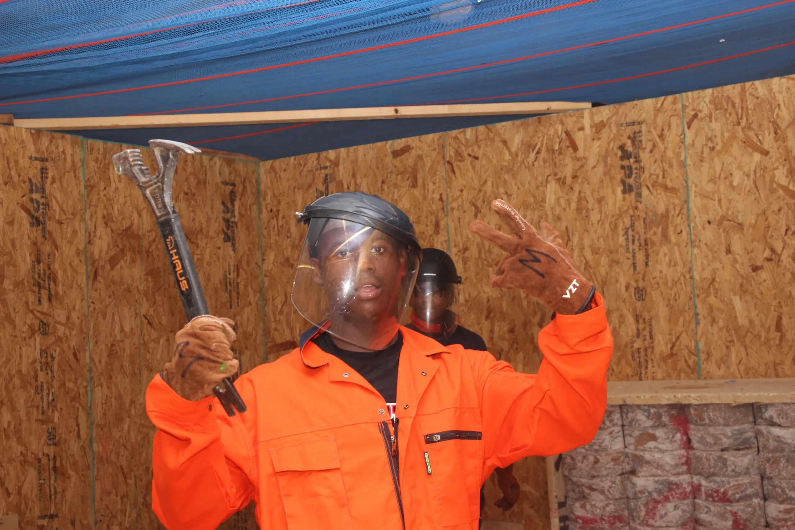 Group geared up with a crowbar before a rage room session in Albany, GA